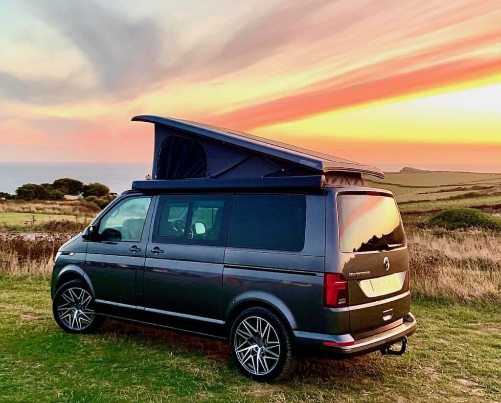 Custom camper van with a pop-top roof, ideal for outdoor adventures and camping trips. Perfect for t.