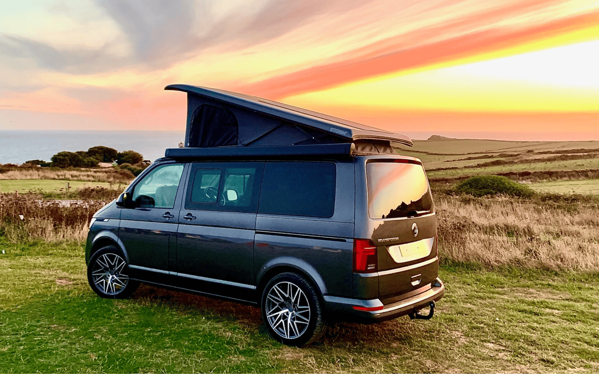 Van with pop-up roof, ideal for camping and outdoor adventures.