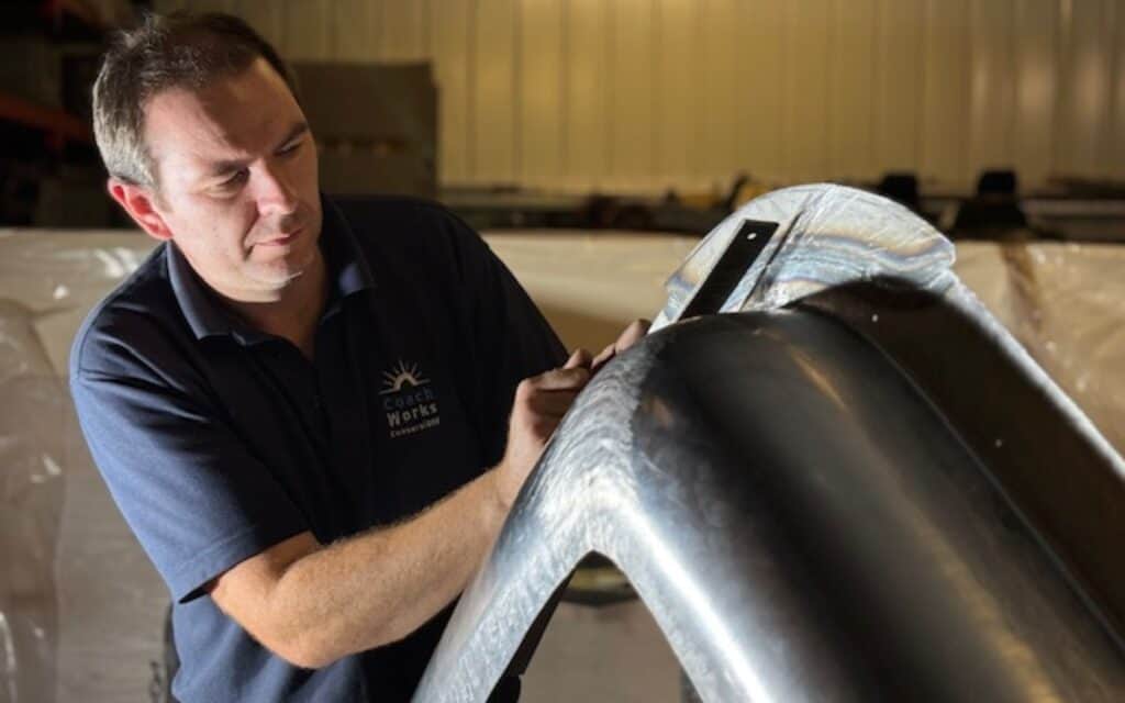 Skilled technician repairing a classic car body at Luke Martin Coachworks.