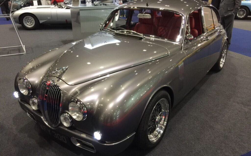 Vintage silver Jaguar XK coupe displayed at Luke Martin Coachworks.
